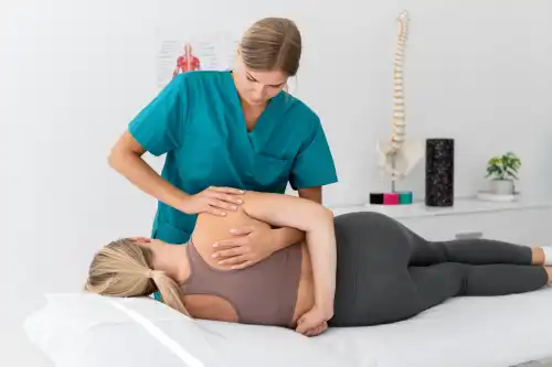 physiotherapist helping patient her clinic