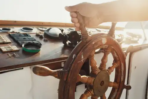 sun shines wooden wheel held by man